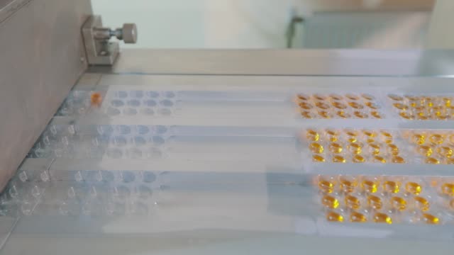 Tablet-manufacturing-process.-Industrial-interior-at-a-pharmaceutical-factory.-Blister-packing-of-tablets.