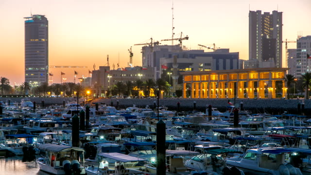 Yachts-and-boats-at-the-Sharq-Marina-night-to-day-timelapse-in-Kuwait.-Kuwait-City,-Middle-East