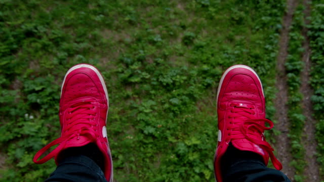 POV-Cableway-view-Chairlift-in-forest-red-sneakers