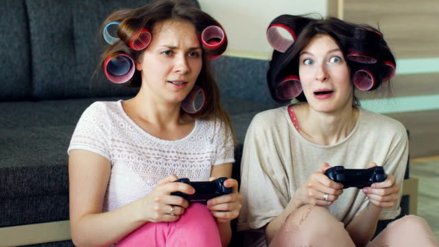 Slow-motion-of-two-funny-women-play-console-games-with-gamepad-and-have-fun-at-home
