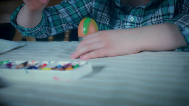 4K-Home-Shot-Of-Child-Painting-Easter-Eggs