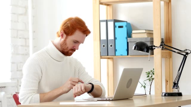 Using-Smartwatch,-Browsing-Man-with-Red-Hairs