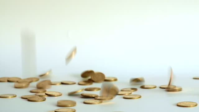 Gold-coins-falling-down-on-white-background,-growth-business-concept,-4K,-UHD.