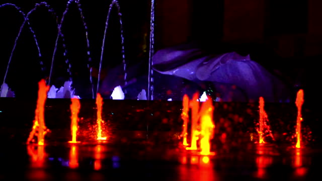 Night-city-lights-and-glowing-fountains