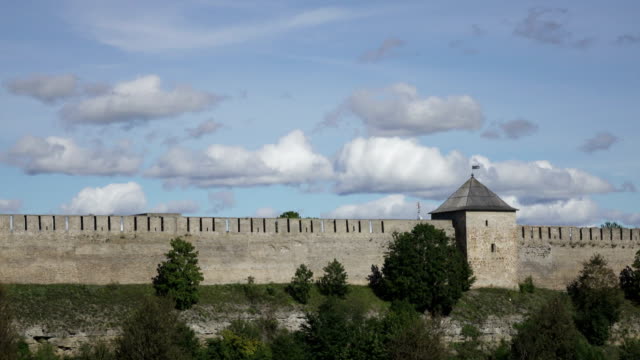 Beautiful-cityscape,-medieval-touristic-attraction-on-Russian-Estonian-border,-Ivangorod-fortress-on-banks-of-Narva-river,-cloudy-sky-horizon