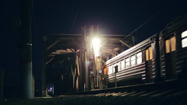 Passenger-train-crosses-bridge-at-night
