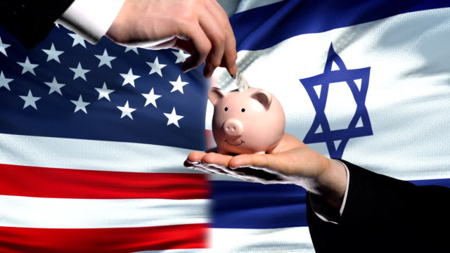 US-investment-in-Israel,-hand-putting-money-in-piggybank-on-flag-background
