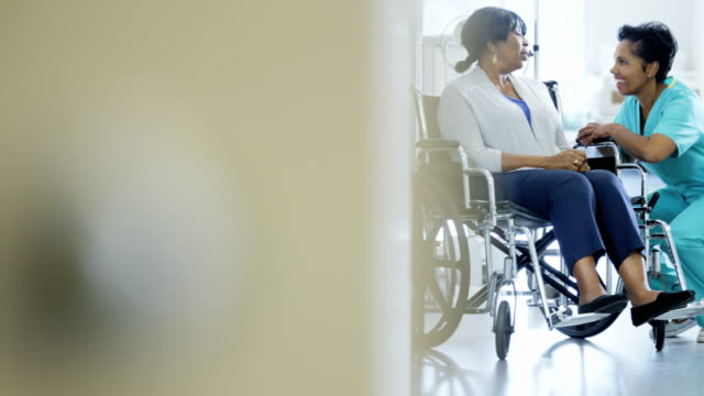 Portrait-of-ethnic-nurse-and-patient-in-wheelchair