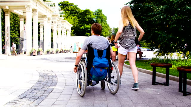 Young-disable-man-walking-in-the-park-with-his-wife