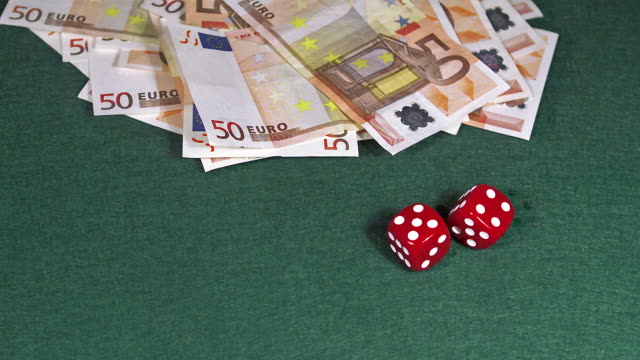 Red-Dice-rolling-against-Green-background-with-50-euros-Money,-slow-motion