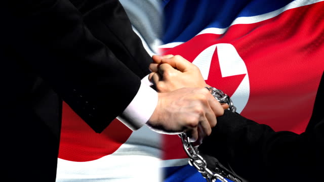 Japan-sanctions-North-Korea,-chained-arms,-political-or-economic-conflict