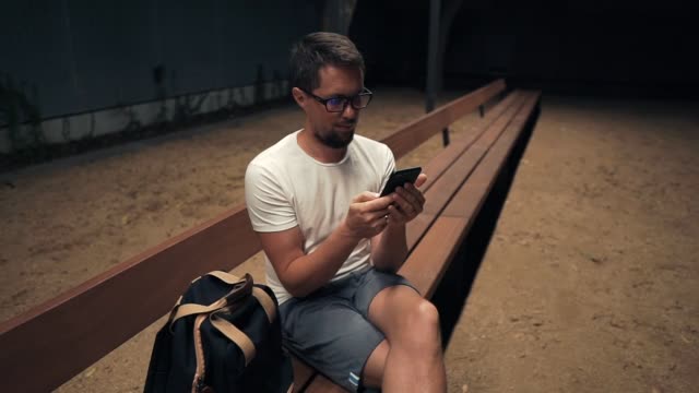Man-with-smartphone-at-night-in-city.