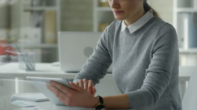 Businesswoman-Working-on-Digital-Tablet-at-Office-Desk