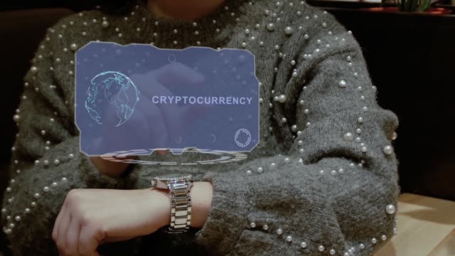Woman-uses-hologram-watch-with-text-Cryptocurrency