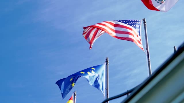 Flags-of-the-USA-and-the-European-Union-waving-in-Slow-Motion