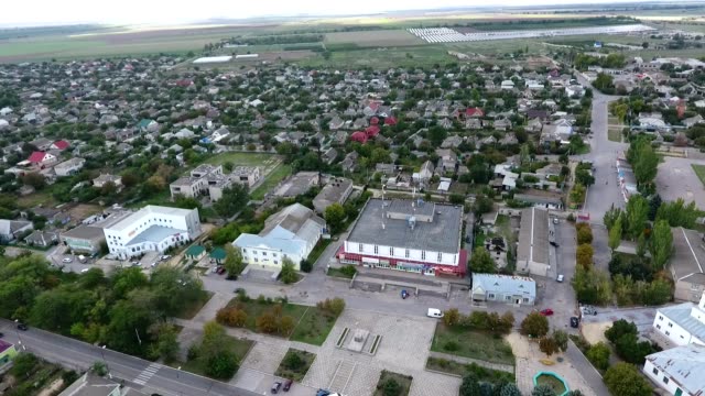 Panoramic-bird`s-eye-view-of-a-big-city-in-the-south-of-Ukraine-with-large-business-buildings,-small-private-houses-and-parks-in-summer