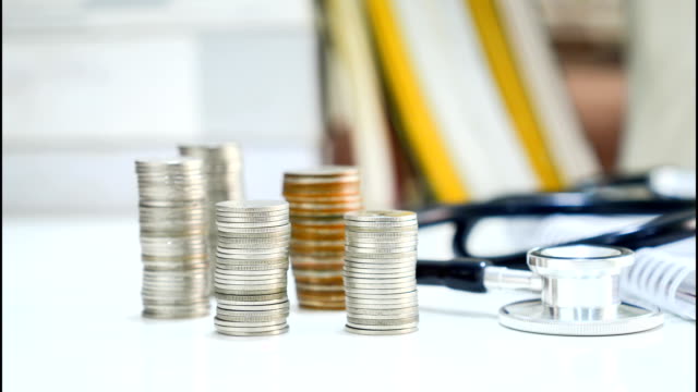 Time-lapse-of-Money-coins-stacked-decrease-with-stethoscope
