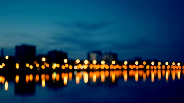 Waterfront-area-of-city-in-night-time,-defocused-shot-of-street-lights-blurred
