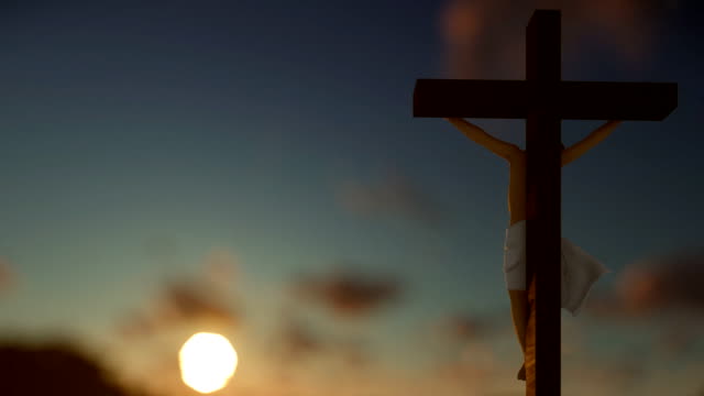 Christians-praying-at-Jesus-cross,-blurry-sunrise