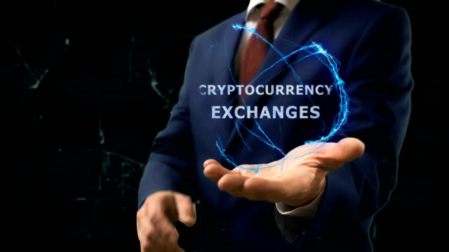 Businessman-shows-concept-hologram-Cryptocurrency-exchange-on-his-hand
