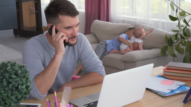 Multitasking-father-babysitting-and-working