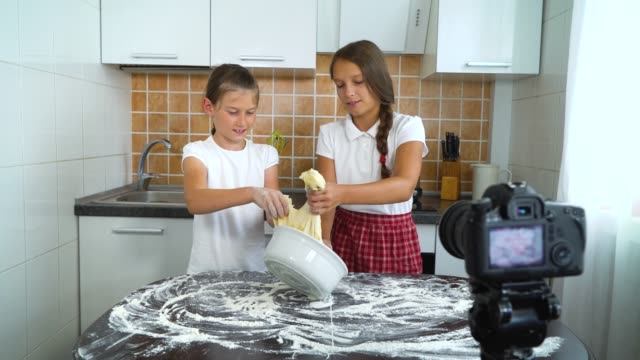 Young-vloggers-recording-video-content-for-food-blog-preparing-for-dough-kneading