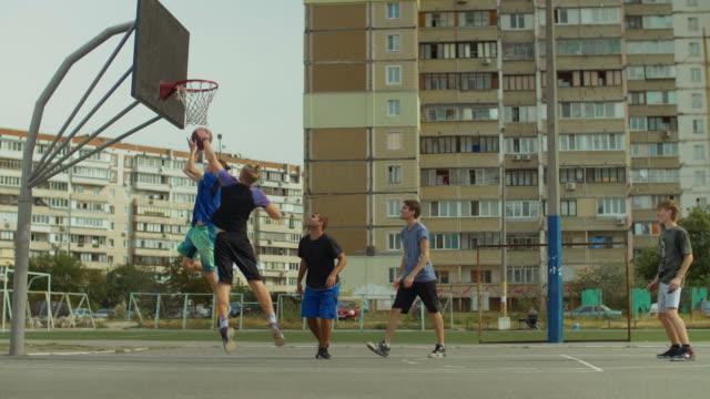 Handsome-streetball-player-doing-reverse-layup