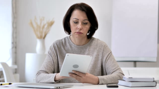 Old-Senior-Woman-Browsing-Internet-on-Tablet