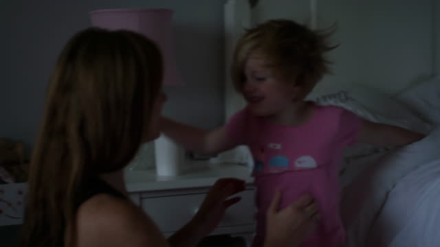 A-little-girl-waking-up-in-the-morning-gets-out-of-bed-and-gives-her-mom-a-big-hug