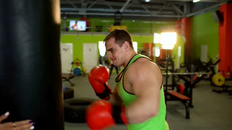 Young-boxer-man-practicing-on-a-punching-bag