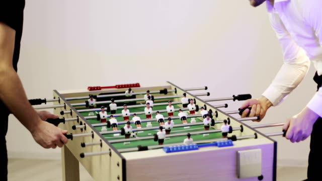 4K-Two-men-playing-table-soccer.