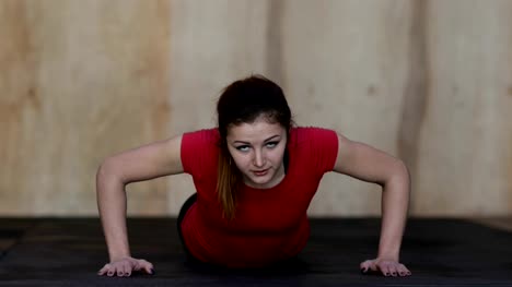 Young-Woman-Doing-Push-Ups-Exercise-During-Workout-Training-At-Gym