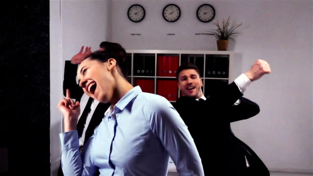 happy-colleagues-dancing-in-office-room