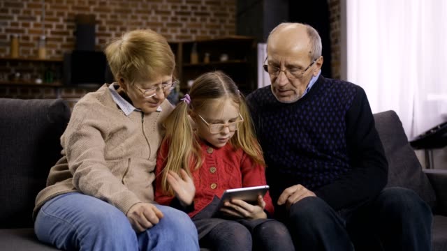 Teen-Mädchen-Unterricht-Großeltern-Touchpad-verwenden