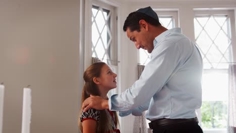 Jewish-man-blessing-his-daughter-before-Shabbat-meal