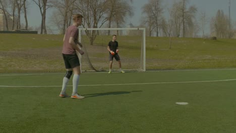 Teenager-goalkeeper-giving-a-pass-to-teammate