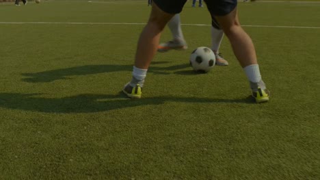Soccer-player-dribbling-and-controls-ball-during-match