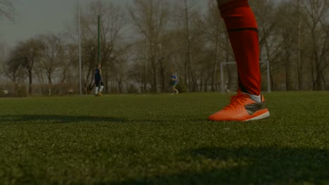 Footballer-kicking-soccer-ball-during-free-kick