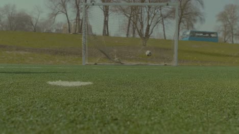 Soccer-player-executing-penalty-kick-during-training