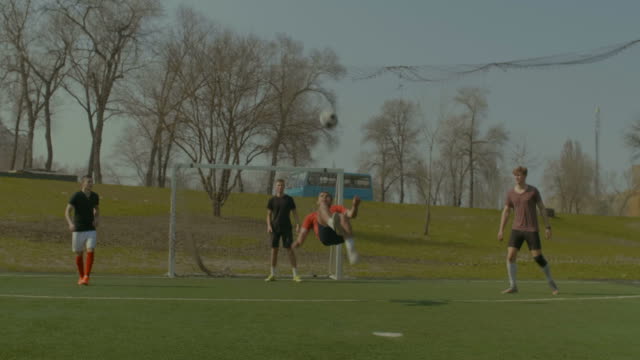 Soccer-player-executing-bicycle-kick-during-game