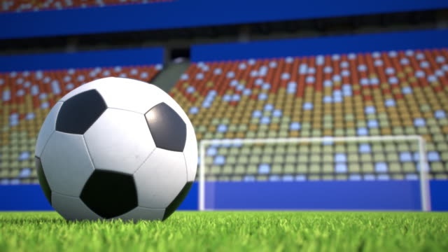 camera-move-towards-a-soccer-ball-lying-on-grass-in-an-empty-stadium