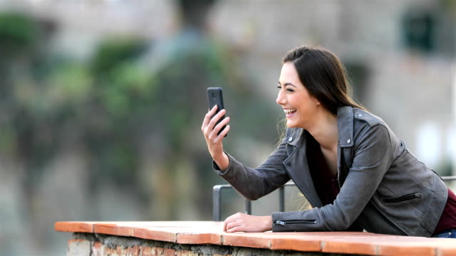 Happy-woman-having-a-video-call-with-a-smart-phone