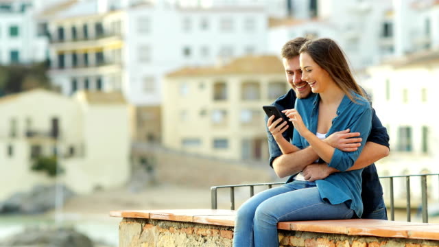 Woman-uses-phone-and-her-partner-arrives-and-share-it