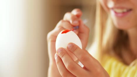 happy-girl-coloring-easter-egg-at-home