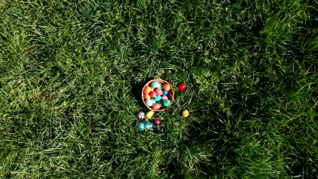 colorful-easter-eggs-in-the-fresh-spring-meadow,-aerial-view