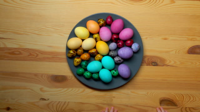 Children-hand-take-colored-Easter-eggs