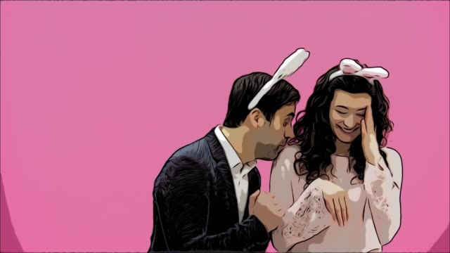 Young-couple-standing-standing-on-pink-background.-During-this-time,-they-are-dressed-in-rabble-ears.-Looking-at-each-other-smiles-sincerely.-Easter-Concept.
