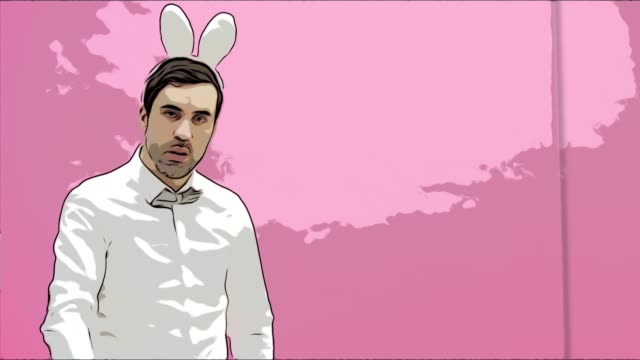 Beautiful-boy-standing-on-a-pink-background.-During-this-dressed-in-a-white-shirt.-Holding-a-carrot-wants-to-burn-it-like-a-cigar.-After-a-while,-he-throws-carrots-to-the-ground.-Dressed-in-white-rabbit-ears.-Easter.