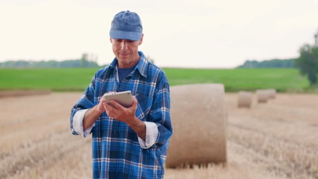 Modern-Farming.-Love-of-Agriculture.-Farmer-using-digital-tablet-while-examining-farm