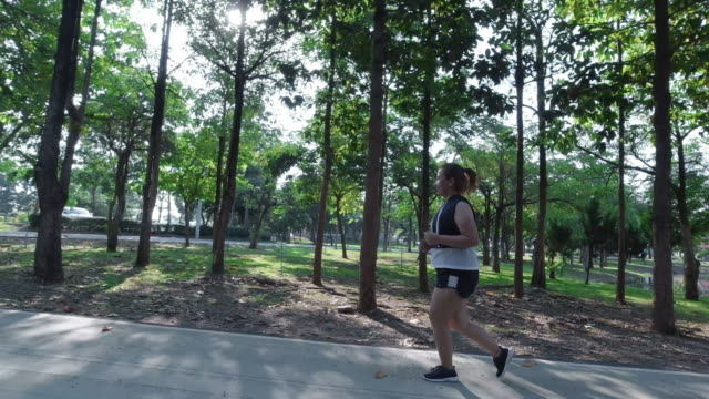 Asian-women-jogging-in-the-street-in-the-early-morning-sunlight-in-garden.-concept-of-losing-weight-with-exercise-for-health.